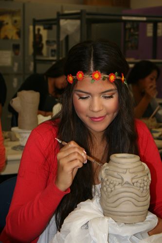 Student creating ceramics vase